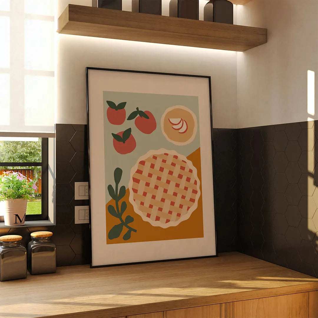 Plakat z ilustracją szarlotki wiszący na ścianie w nowoczesnej, przytulnej kuchni