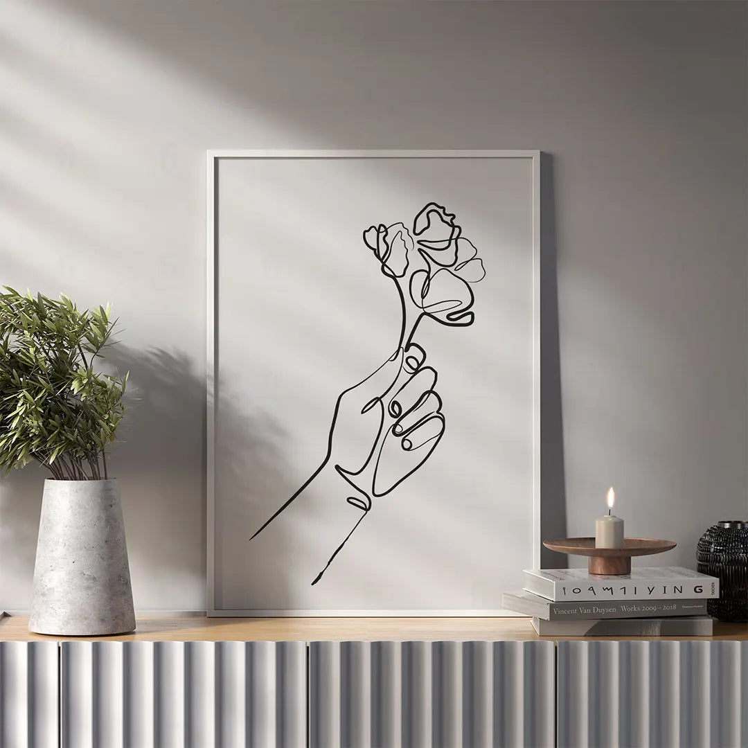 Minimalistyczny rysunek wykonany jedną linią, przedstawiający dłoń trzymającą kwiat-salon